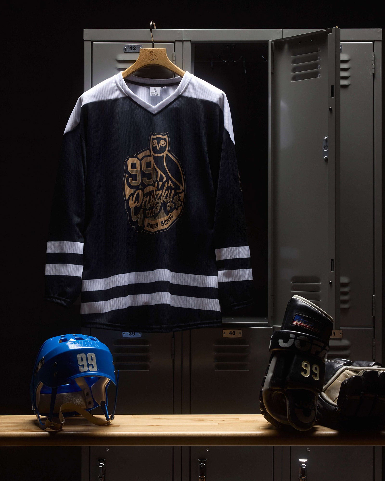 October's Very Own Hockey jersey with number 99, helmet, and skates on a locker shelf.