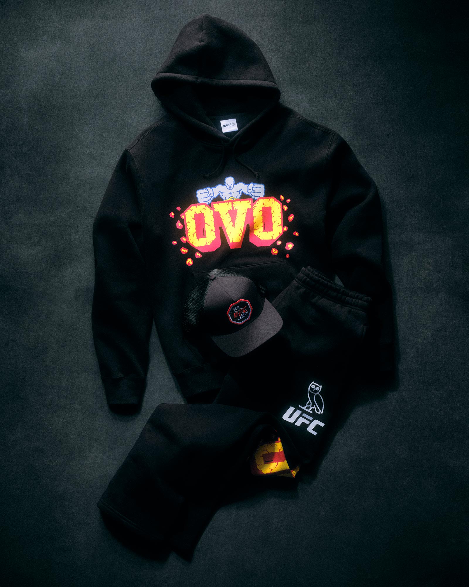 Black hoodie with colorful 'OVO' design and UFC logo on a dark background