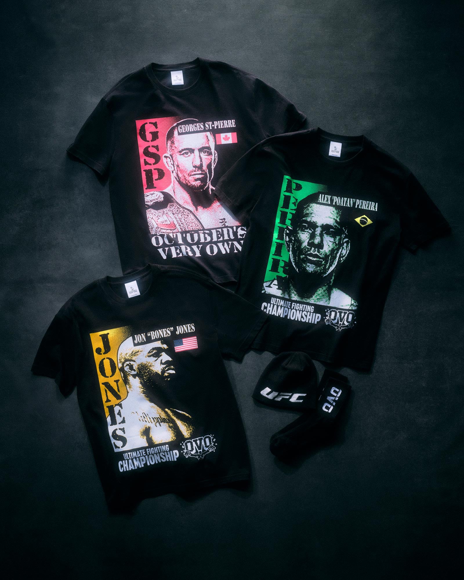 Three black October's Very Own x UFC t-shirts with graphic designs on a dark background