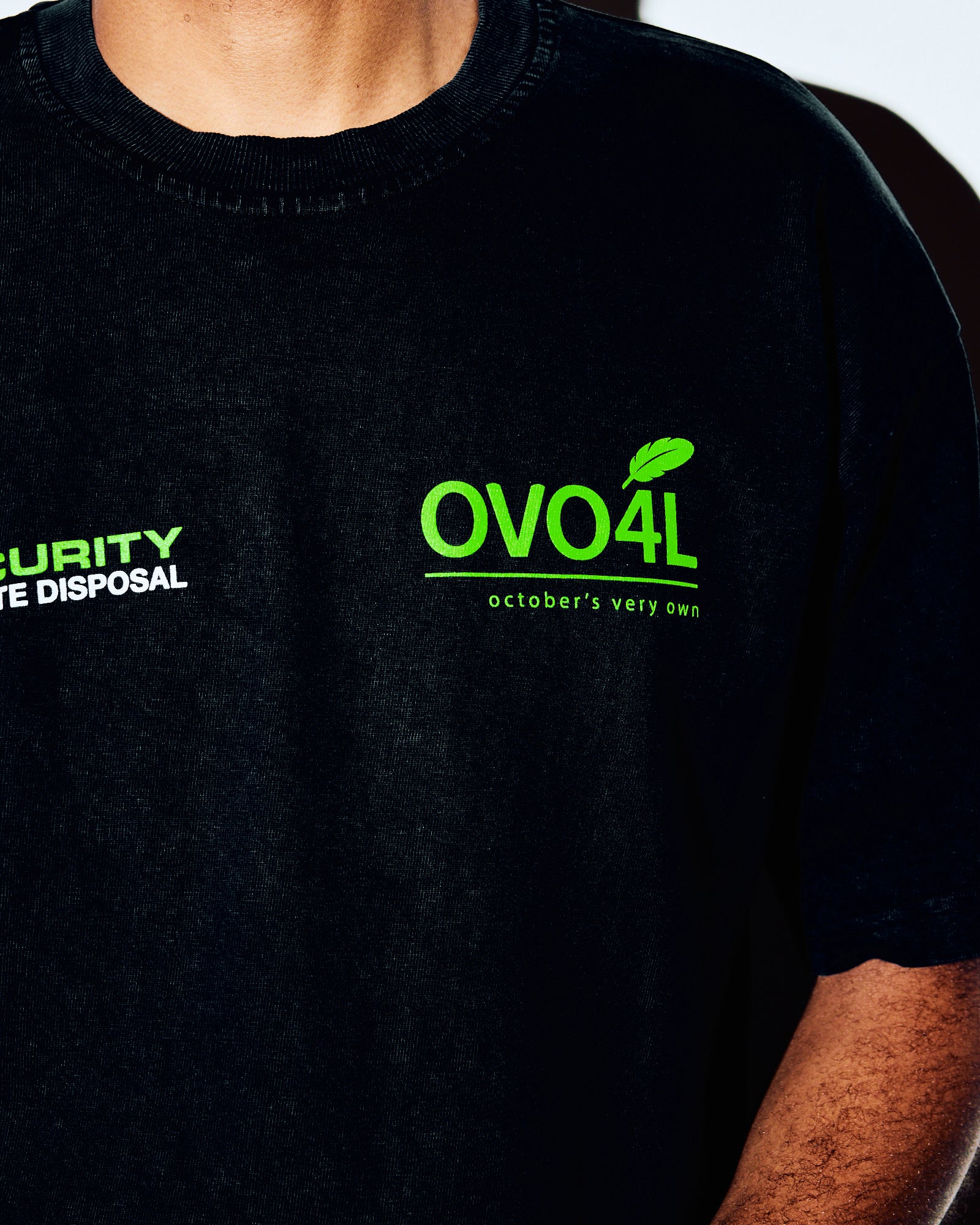 Black crewneck tee with neon green OVO4L and "october's very own" text on chest.