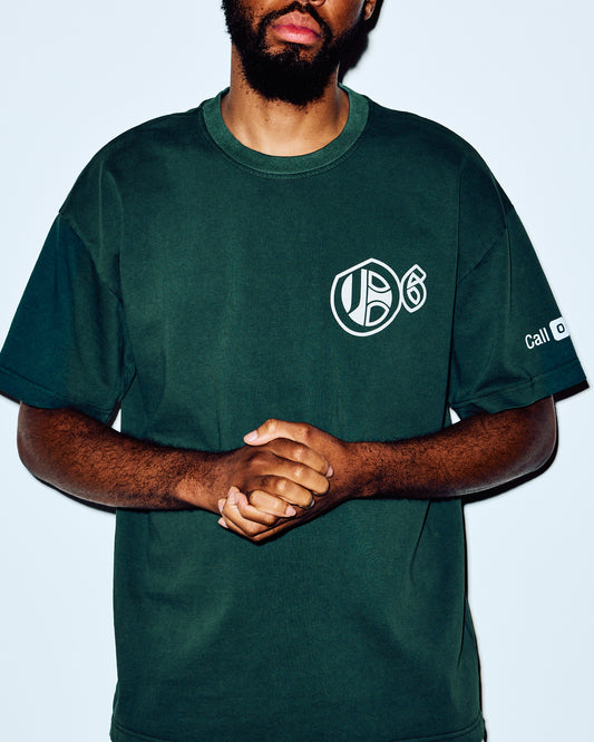 Dark green crewneck t-shirt with white House of October logo on chest and sleeve text.