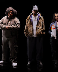 Translation missing: fr.Three people standing side by side against a black background