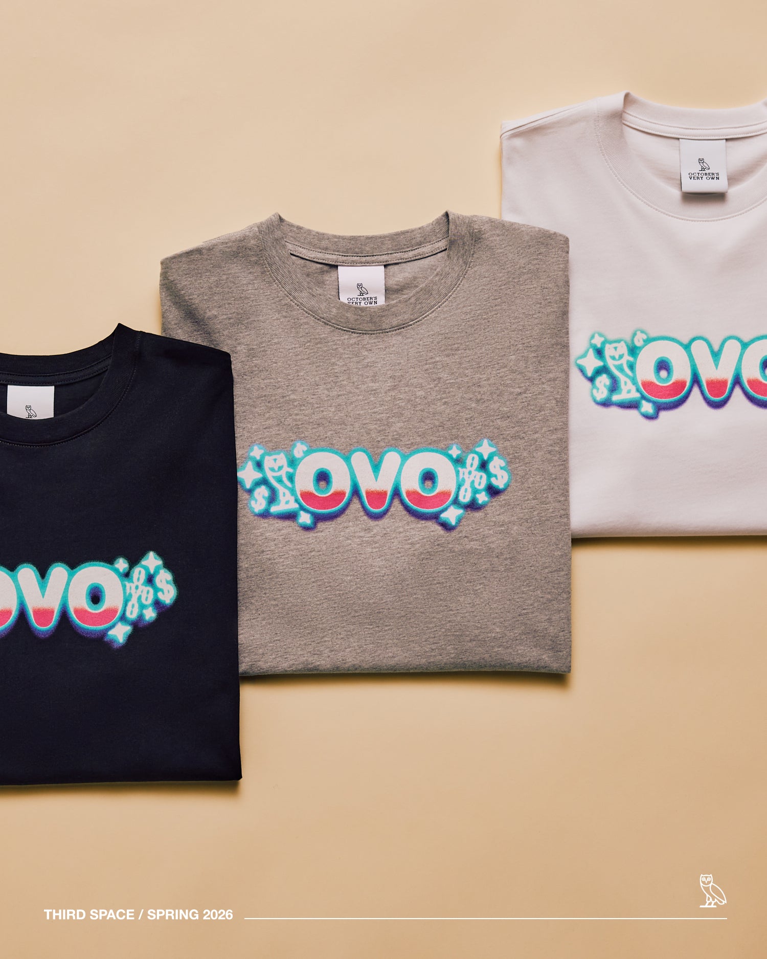 Three t-shirts with 'OVO' design on a beige background