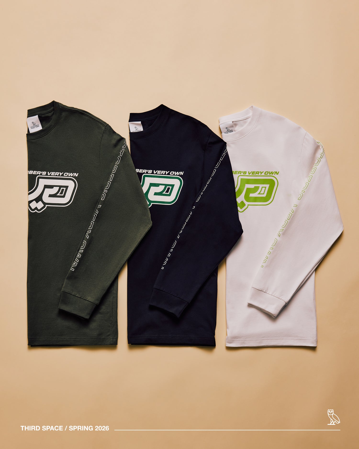 Three long-sleeve shirts in green, black, and white with a October’s Very Own logo on a beige background.
