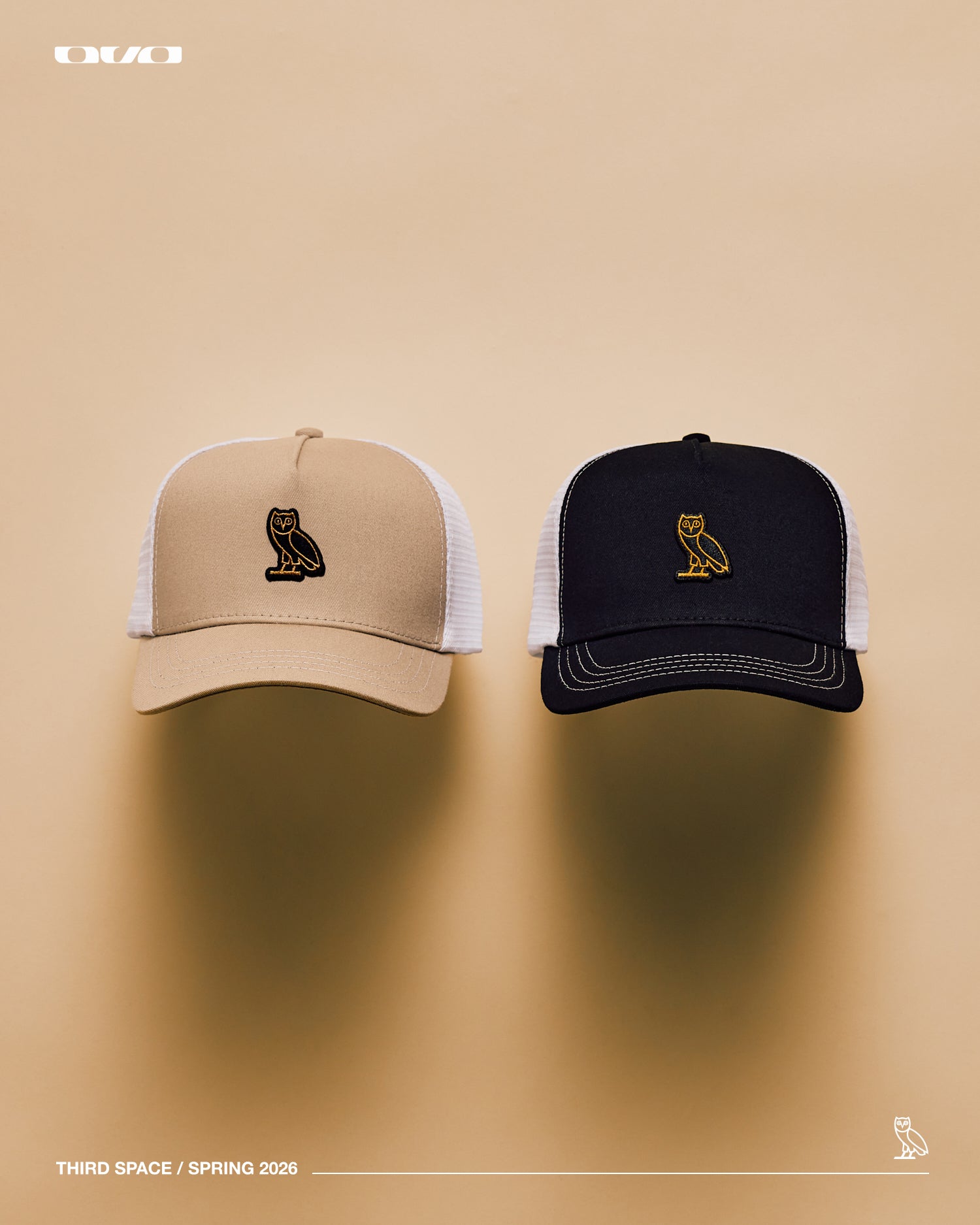 Two October's Very Own caps, one beige and one black with white mesh, on a beige background.