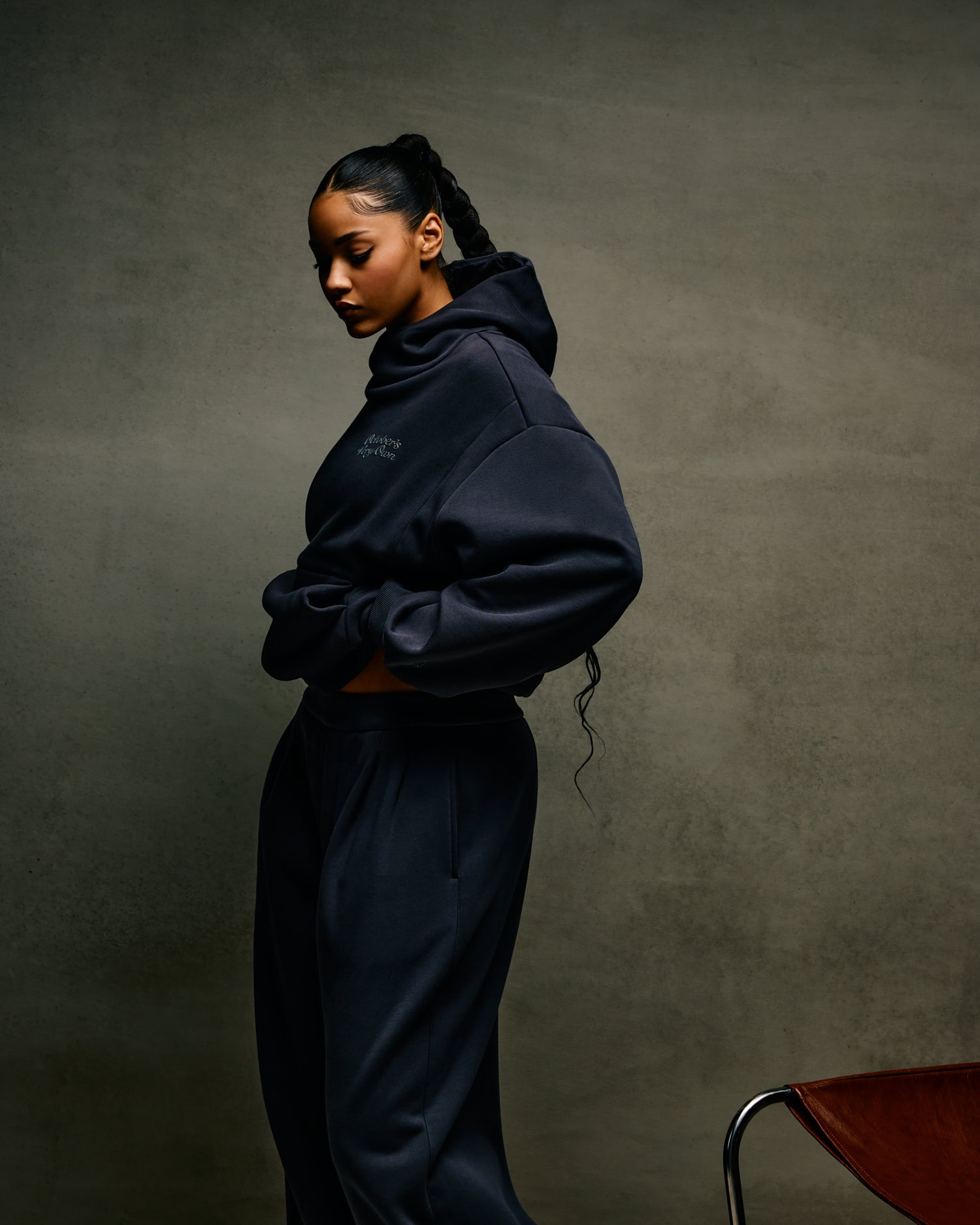 Person wearing a dark October's Very Own hoodie and pants against a plain background