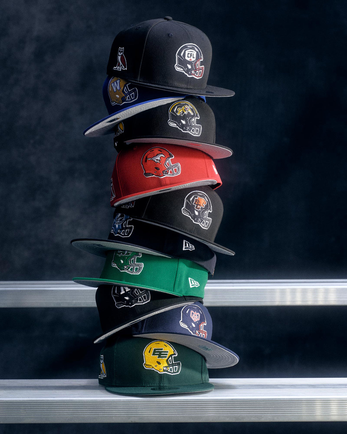 October's Very Own x CFL Fitted hat's stacked on top of each other