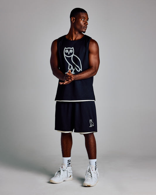 Black mesh shorts with white trim and owl graphic on leg, paired with matching sleeveless tank top.