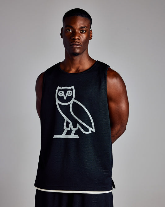 Black mesh basketball jersey with white owl graphic on chest and cream trim at hem.