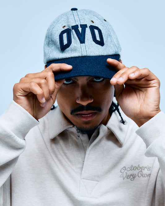 Light gray wool cap with dark navy brim and "OVO" embroidered across the front.