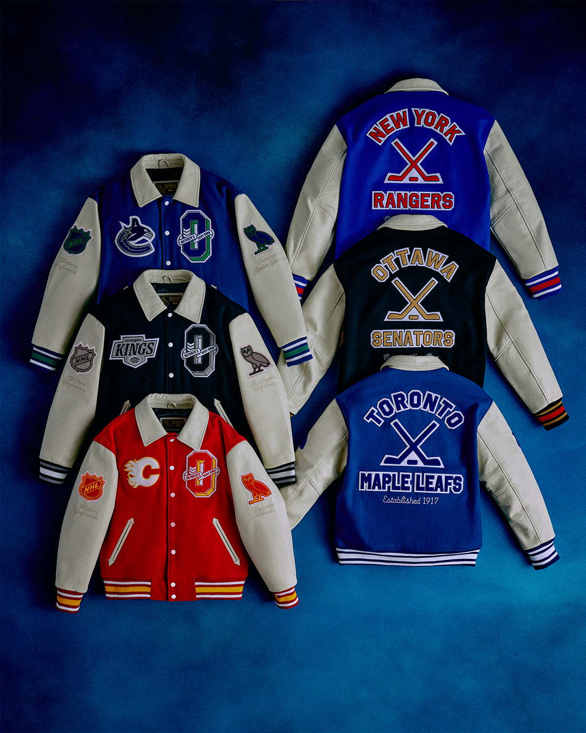 Collection of October's Very Own x NHL   varsity jackets with sports team logos on a blue background