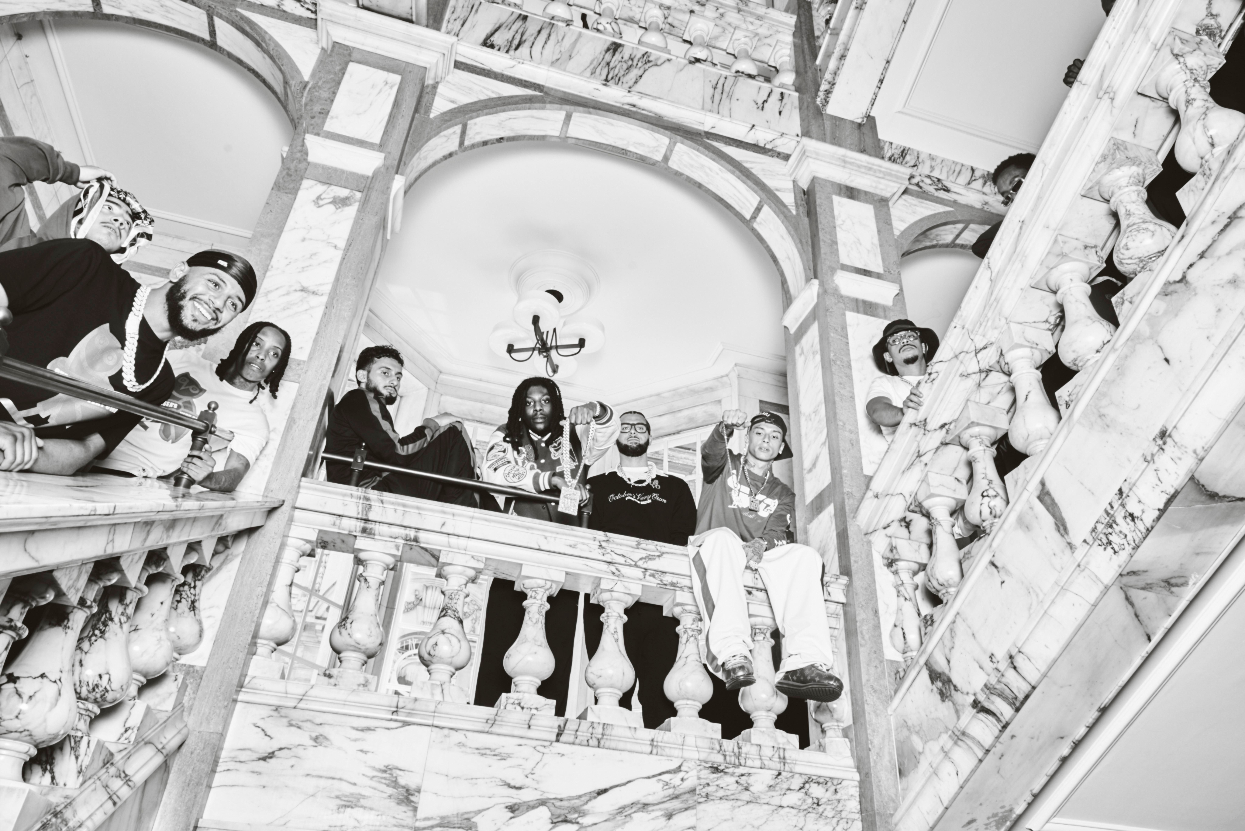 Black and white photo of a group of people on a staircase with decorative elements.