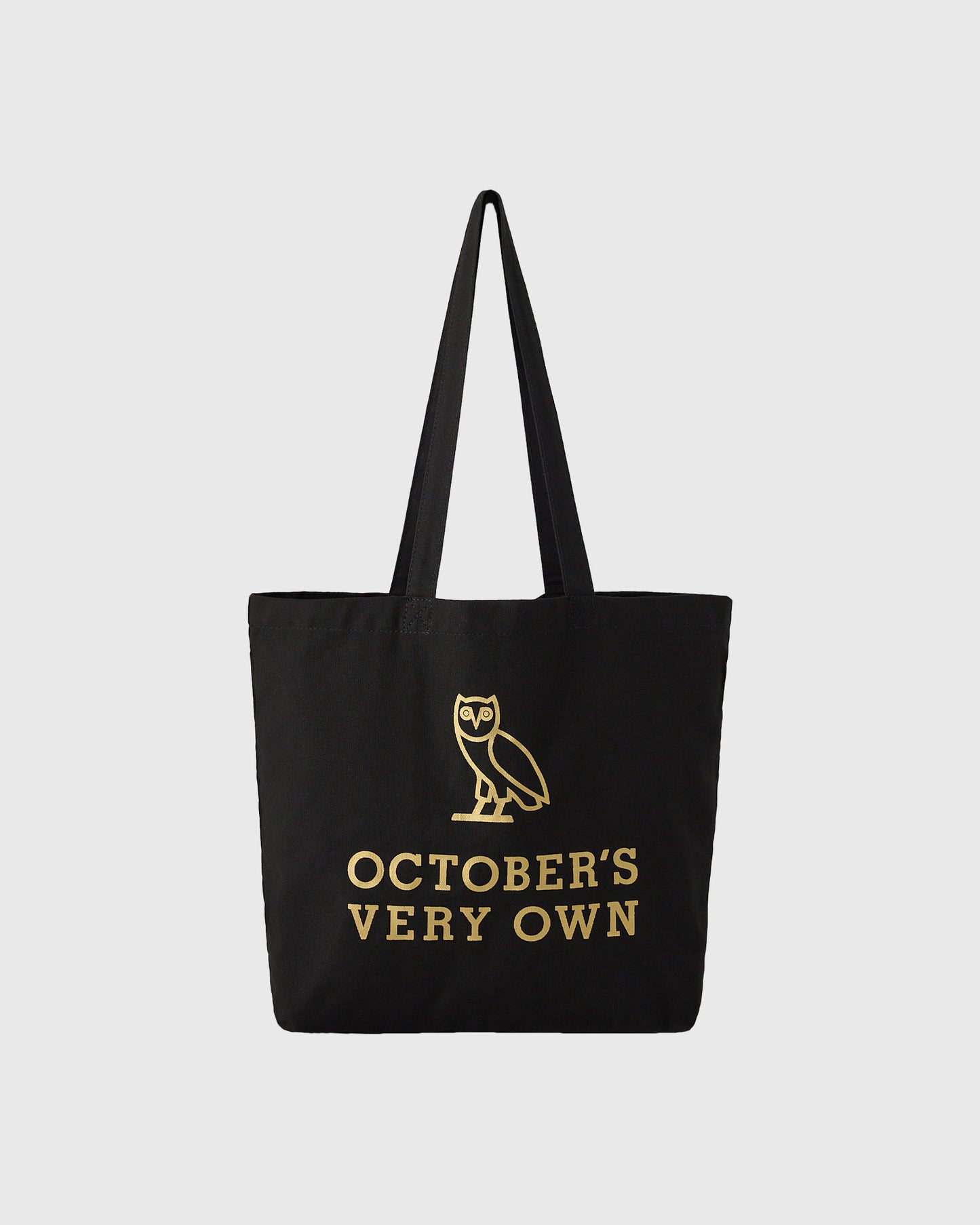 Black tote bag with gold owl illustration and "October's Very Own" text printed on front.