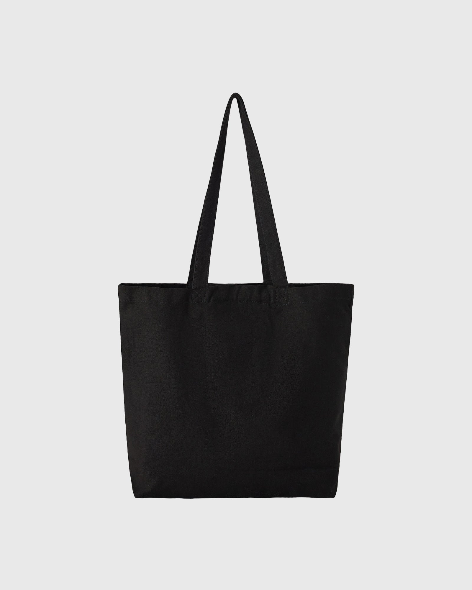 Black canvas tote bag with dual handles and rectangular shape.