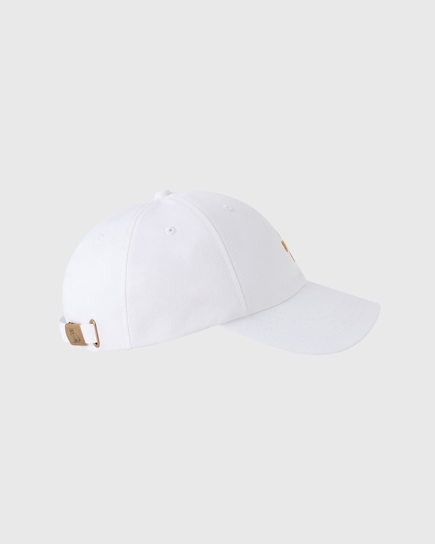 White baseball cap with pom pom on crown, tan adjustable back strap with metal hardware.