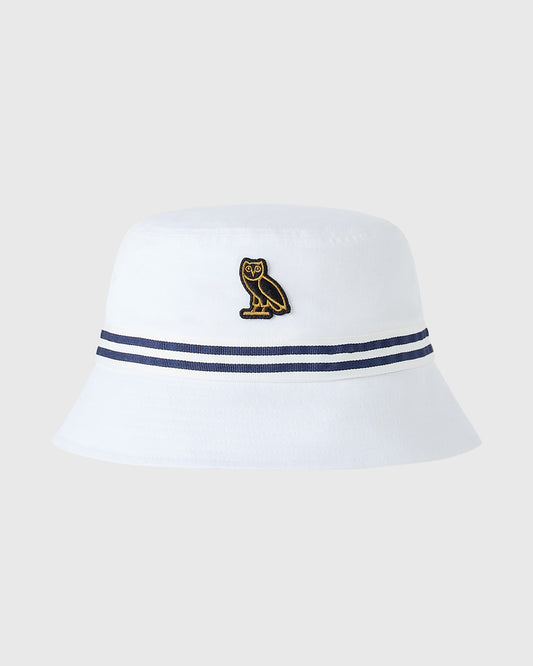 White bucket hat with navy striped band and gold owl embroidery on crown.