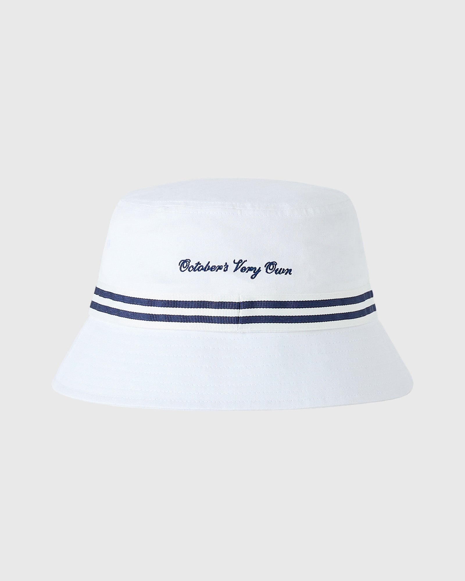White bucket hat with navy striped band and "October's Very Own" embroidered text.
