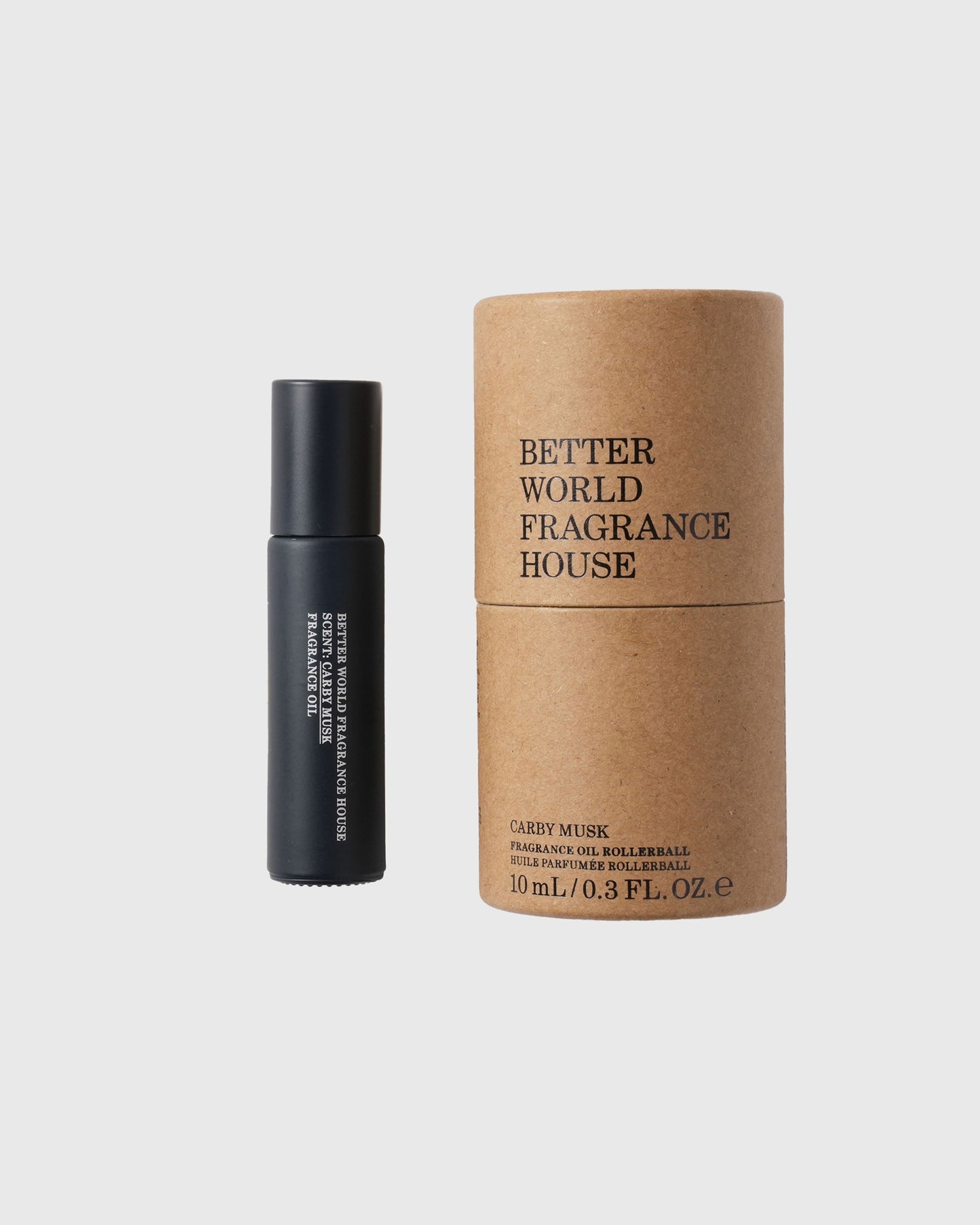Black roller ball bottle with Better World Fragrance House Carby Musk fragrance oil next to kraft paper cylindrical packaging