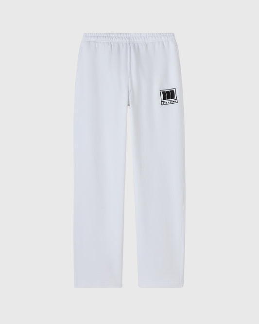 White sweatpants with elasticated waistband and small black OVO Sound logo patch on right thigh.