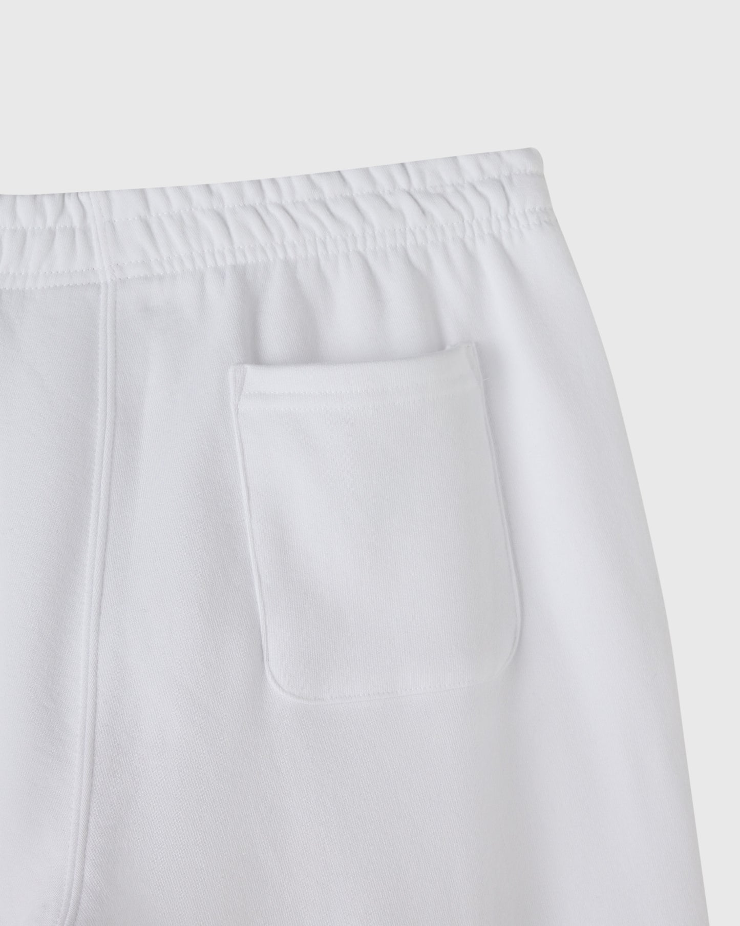 White sweatpant with elastic waistband and front pocket detail.