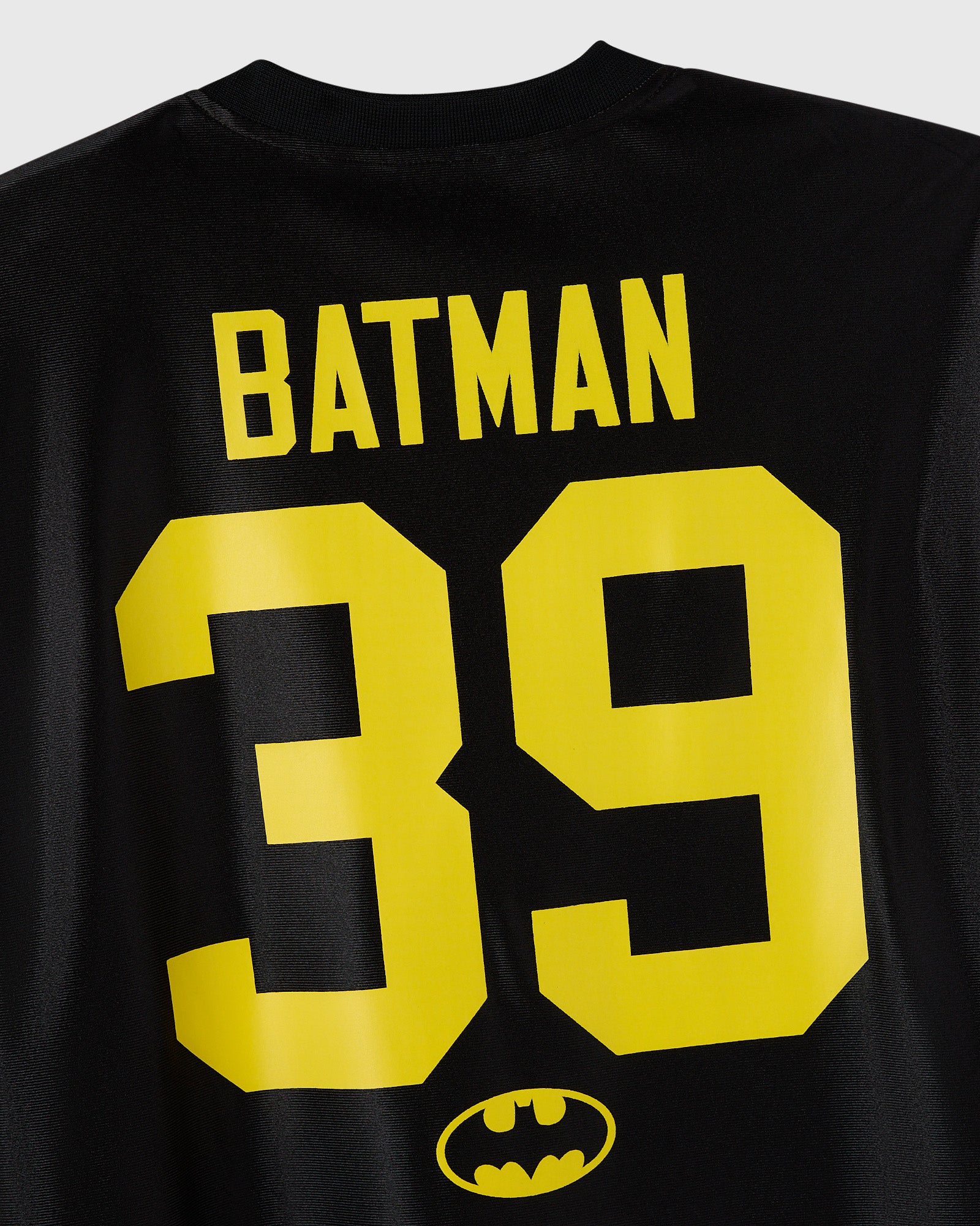 Black jersey with yellow "BATMAN" text, number "39," and bat logo on chest.