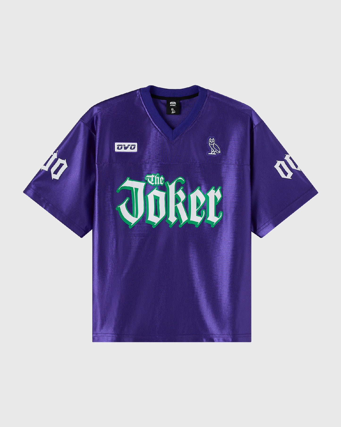 Purple football jersey with "The Joker" text in green across chest, white numbers on sleeves, and small logo patches.