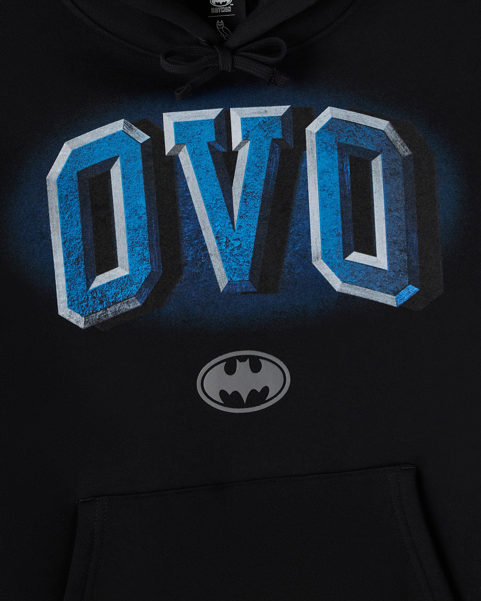Black hoodie with blue and white "OVQ" arch text and gray Batman logo on chest.