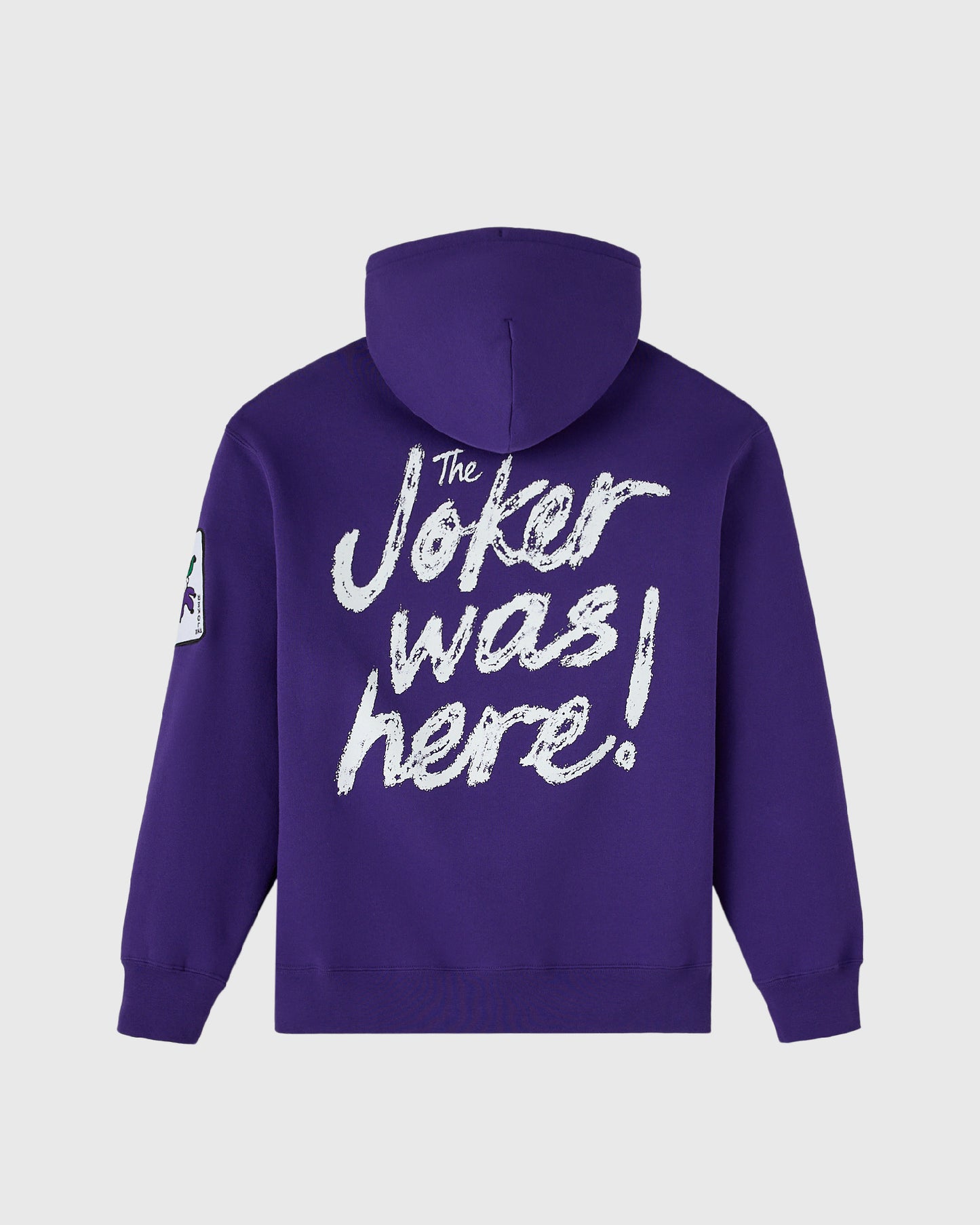 Violet hoodie with white distressed text reading "The Joker was here!" on back and small graphic on left sleeve.