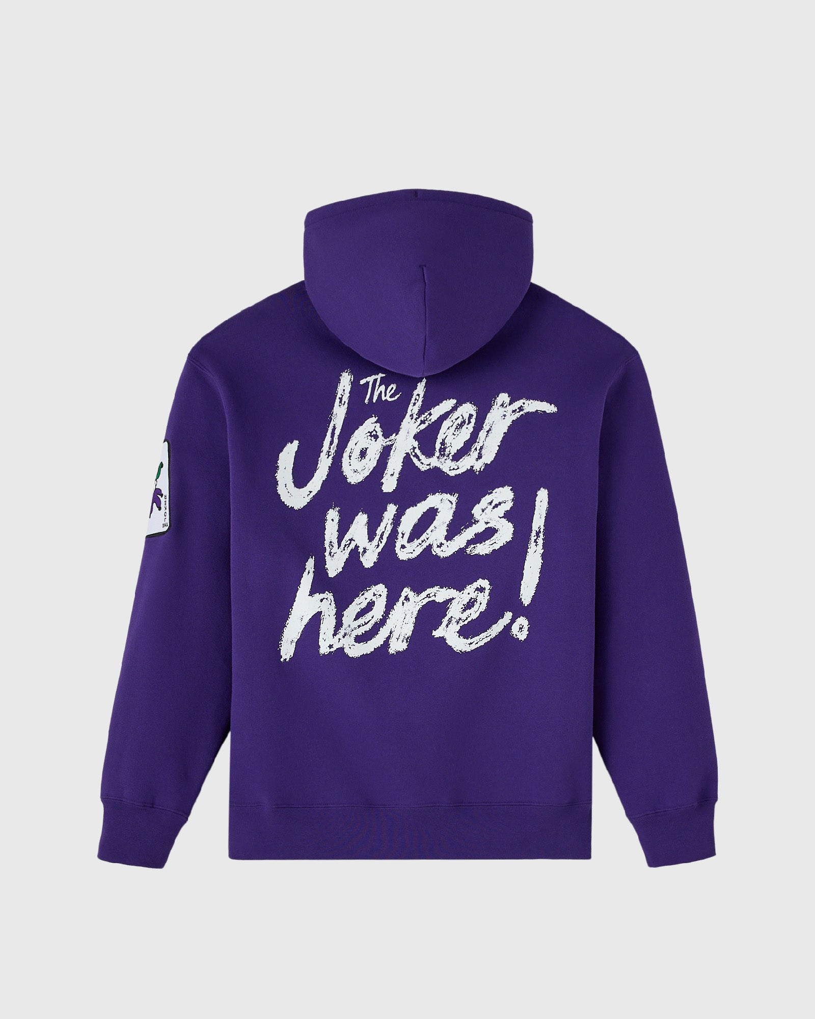Violet hoodie with white distressed text reading "The Joker was here!" on back and small graphic on left sleeve.