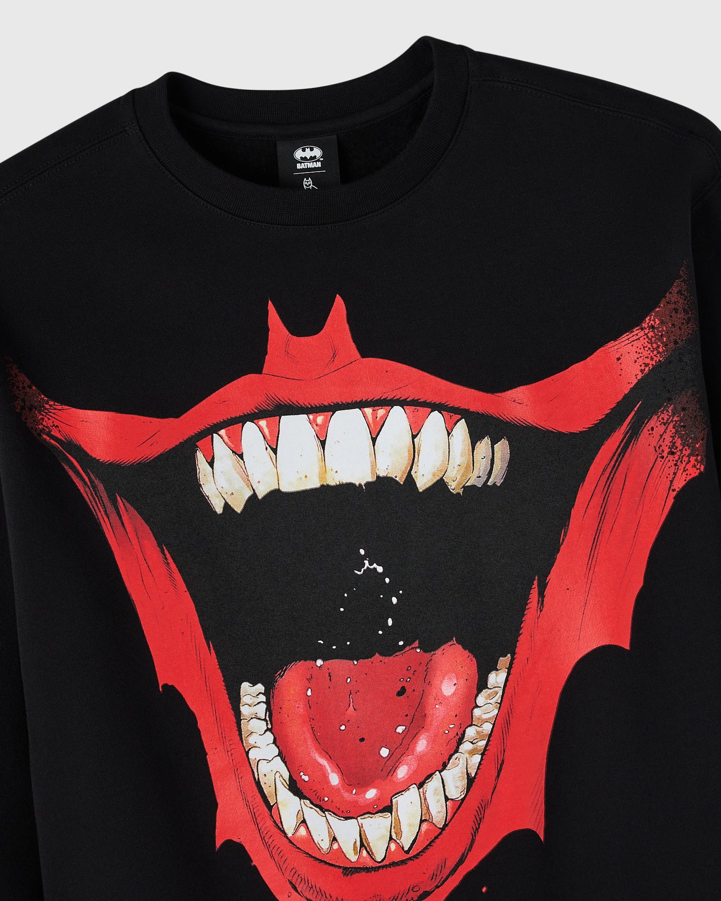Black crewneck sweatshirt with red bat graphic featuring sharp teeth and open mouth design on chest.