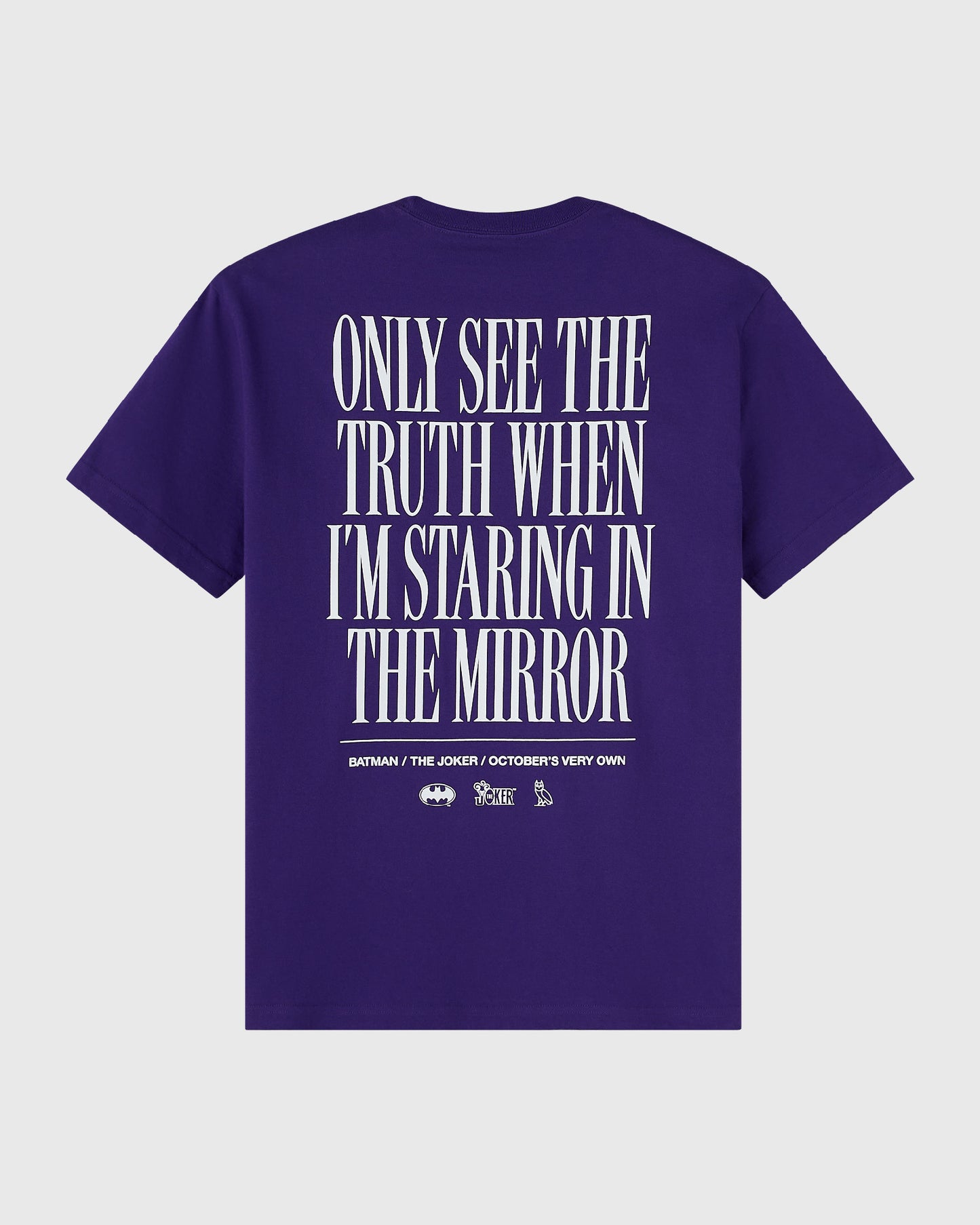 Purple t-shirt with white text reading "Only see the truth when I'm staring in the mirror" and Batman/Joker logos on back.