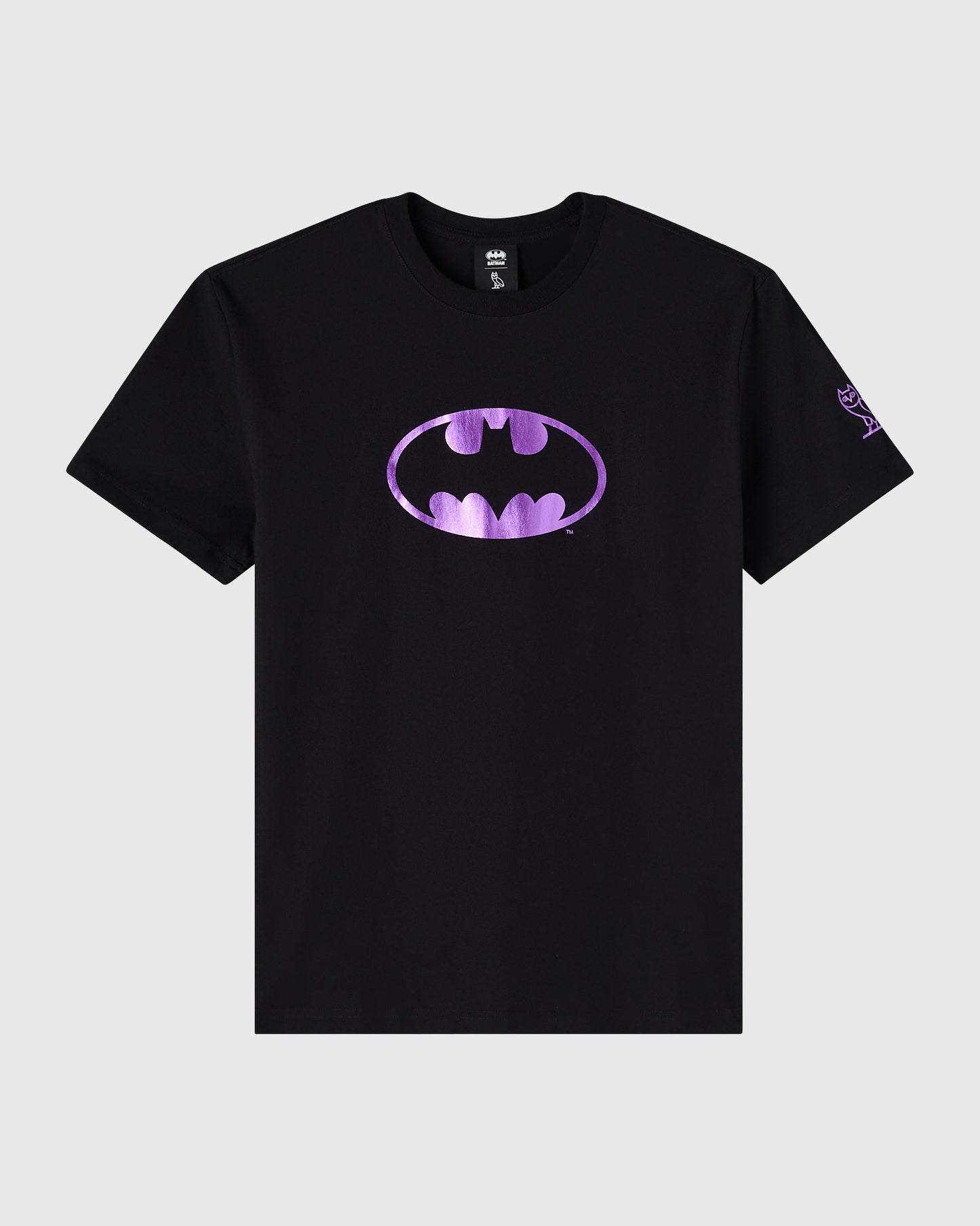 Black crewneck t-shirt with purple Batman logo and small graphic on right sleeve.