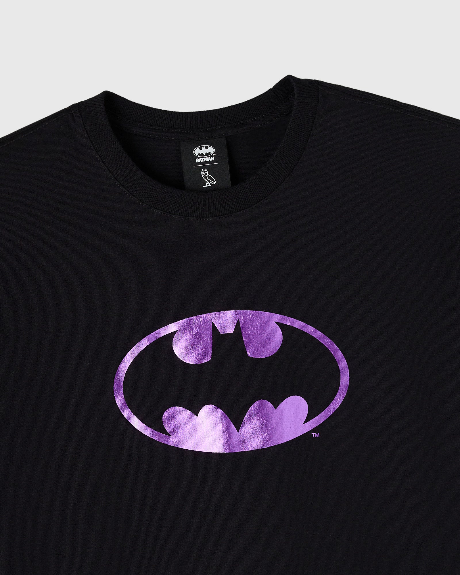 Black crewneck t-shirt with purple metallic Batman logo on chest.
