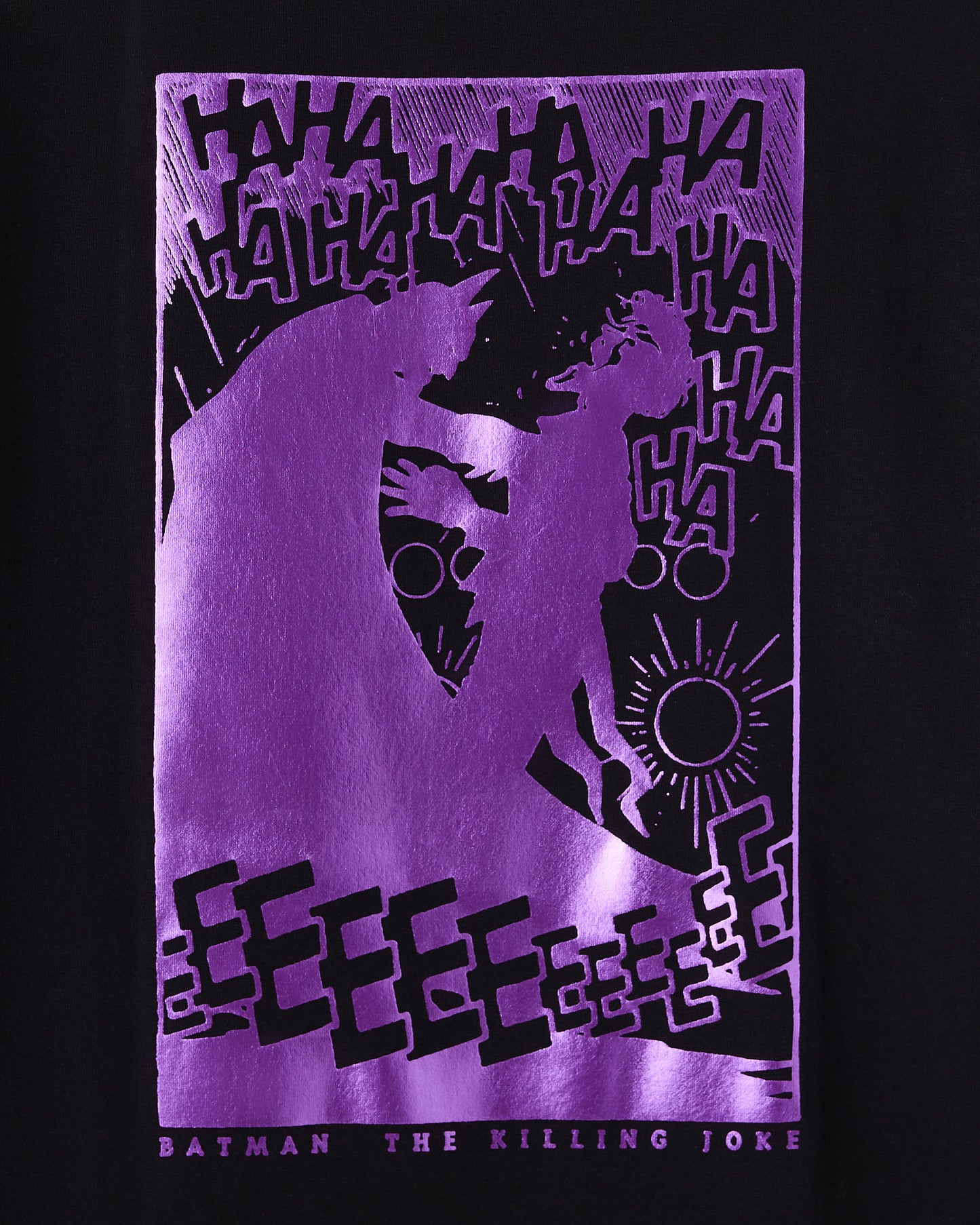 Black t-shirt featuring purple and black graphic design with Batman and Joker silhouettes, "ha ha" text, and sun symbol.