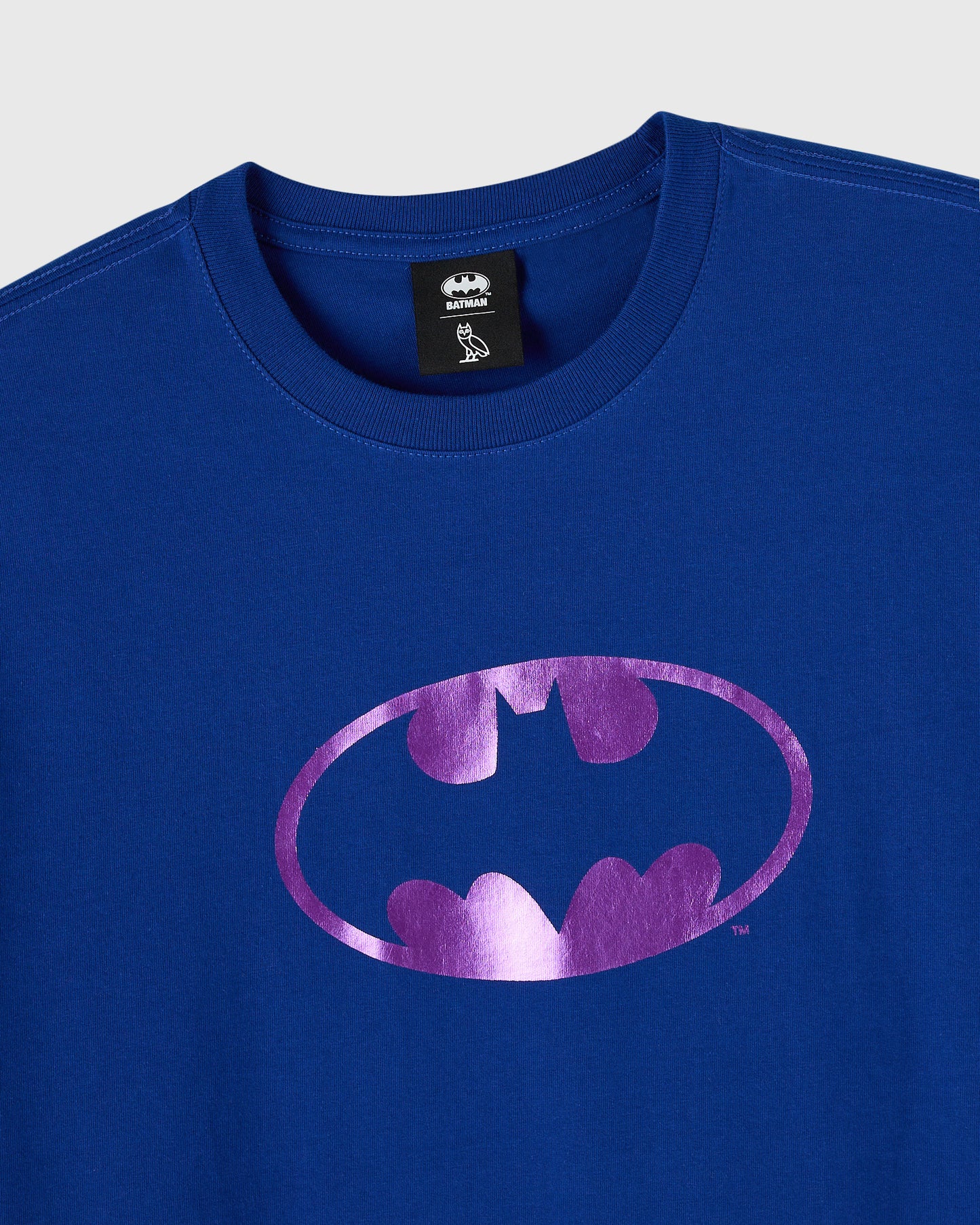 Midnight blue crewneck t-shirt with pink metallic Batman logo on chest.