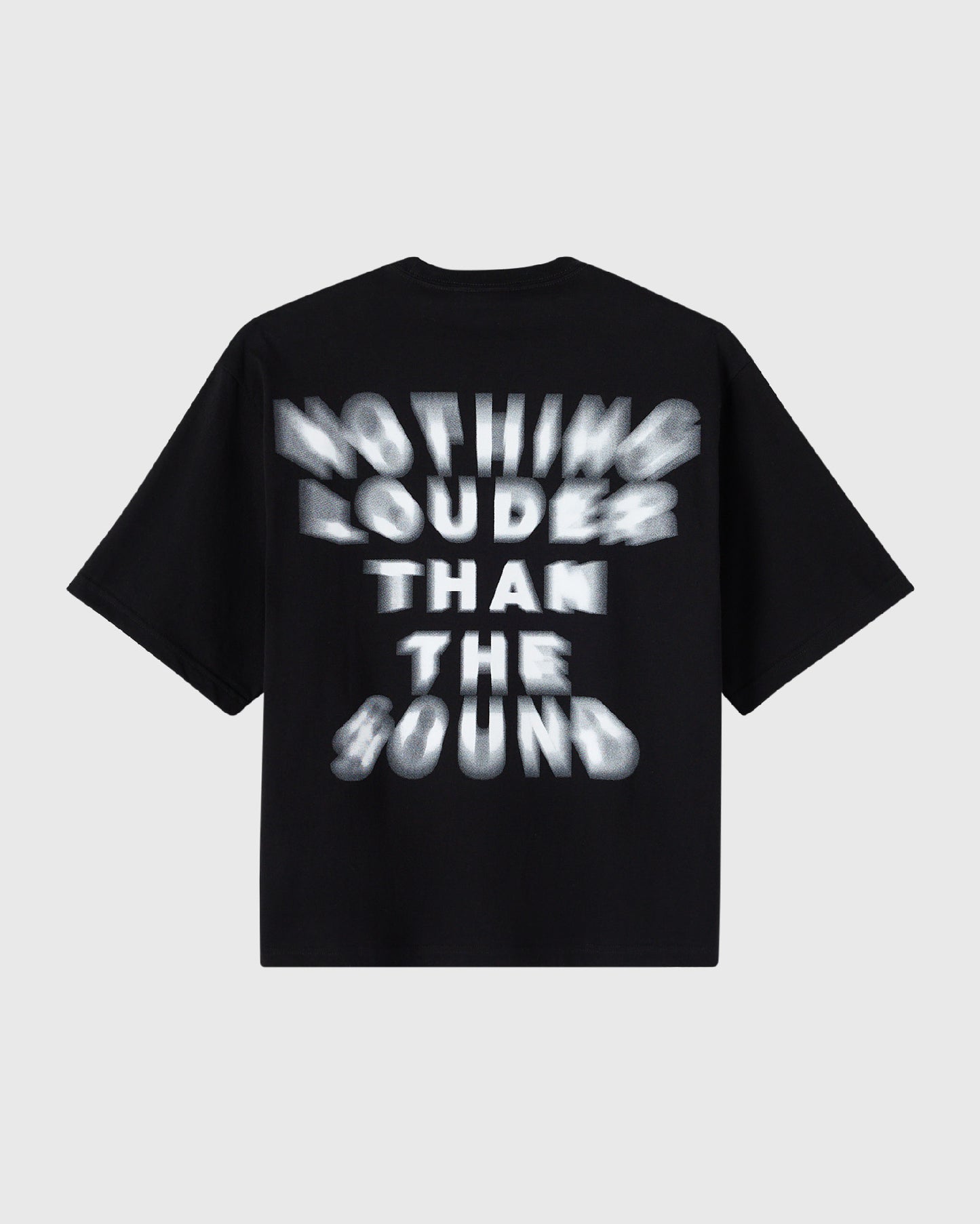 Black t-shirt with white blurred text reading "Nothing Louder Than The Sound" across the chest.