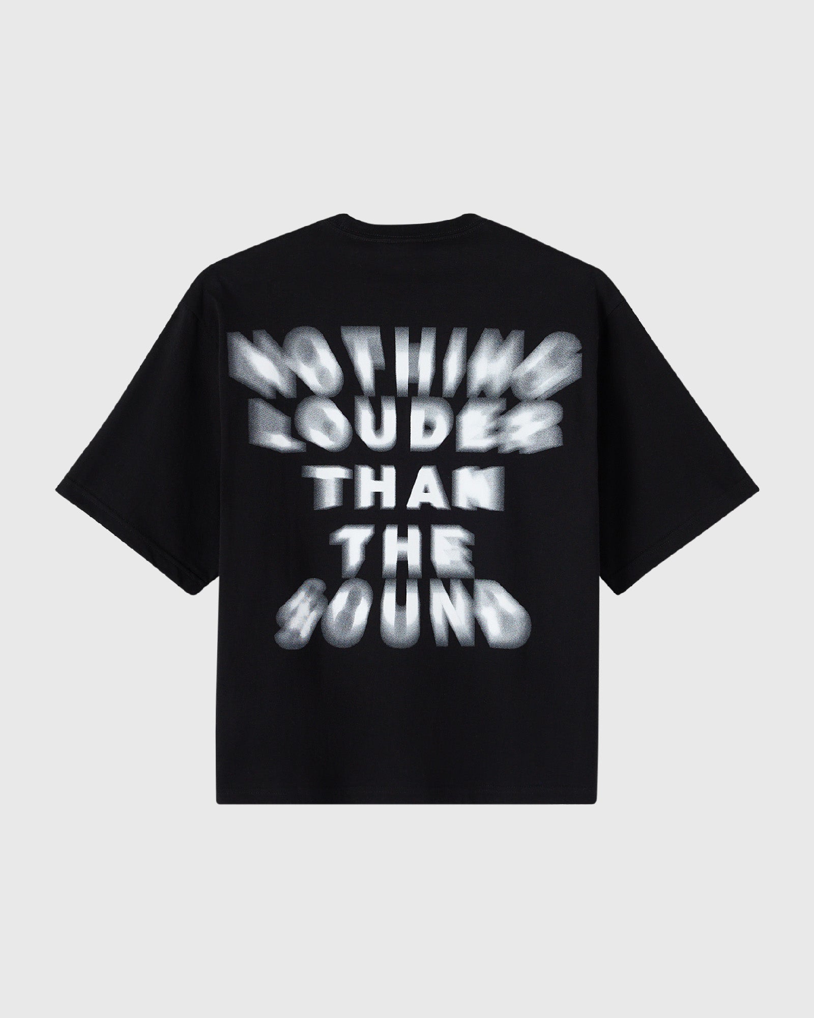 Black t-shirt with white blurred text reading "Nothing Louder Than The Sound" across the chest.