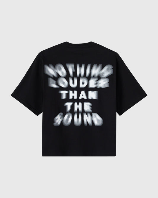 Black t-shirt with white blurred text reading "Nothing Louder Than The Sound" across the chest.