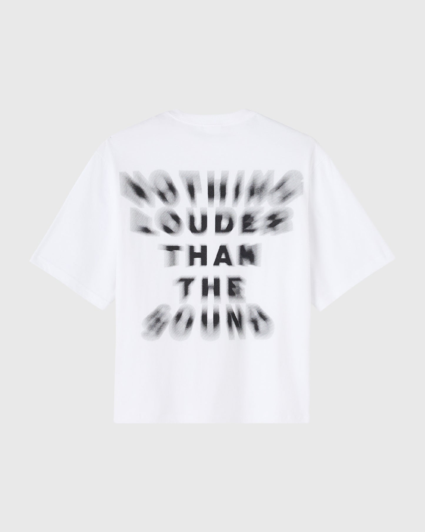White short-sleeve t-shirt with black blurred text reading "Nothing Louder Than The Sound" on the front.