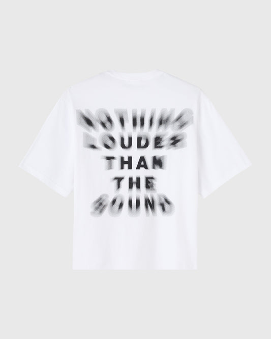 White short-sleeve t-shirt with black blurred text reading "Nothing Louder Than The Sound" on the front.