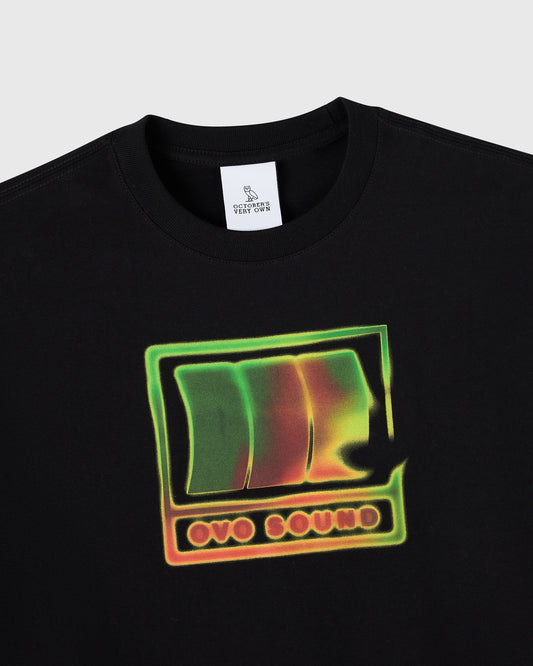 Black crew neck t-shirt with neon green and orange graphic print featuring stylized owl design and "OVO SOUND" text.