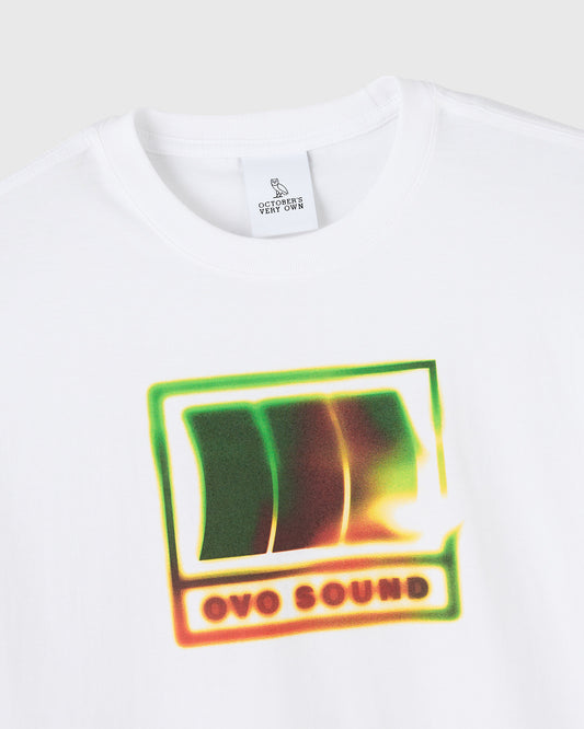 White t-shirt with OVO Sound graphic print in neon green, yellow, and orange gradient colors on chest.