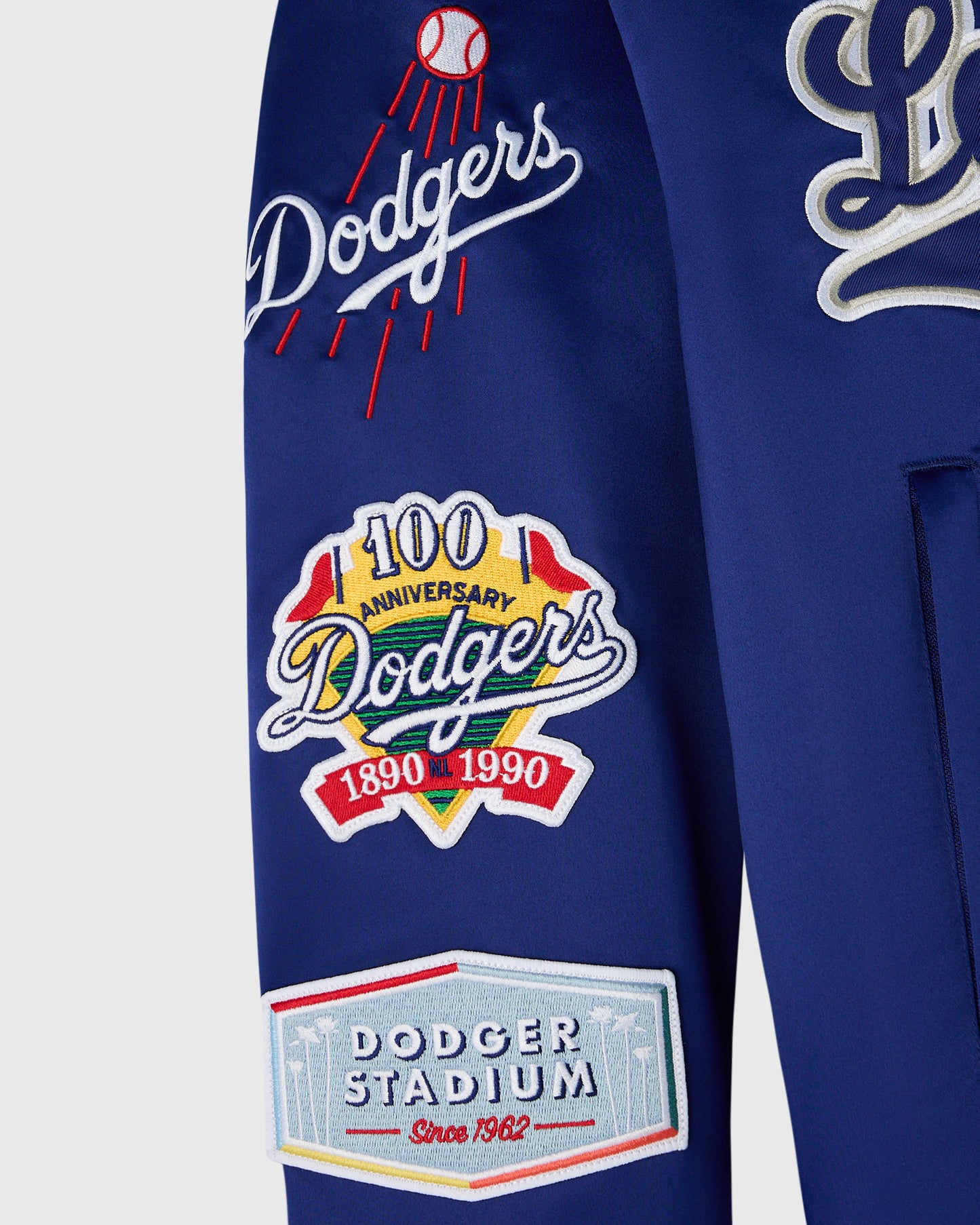 Navy blue varsity jacket with white and red Dodgers logos, baseball emblem, 100th anniversary patch, and Dodger Stadium emble
