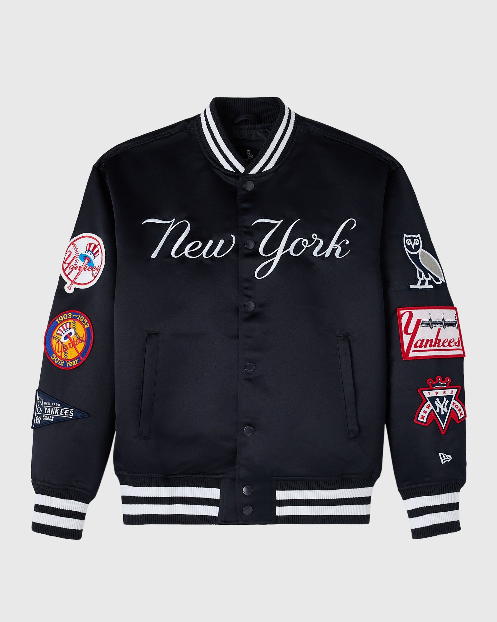 Navy varsity jacket with "New York" script, Yankees patches on sleeves, striped ribbed collar and cuffs, button front closure