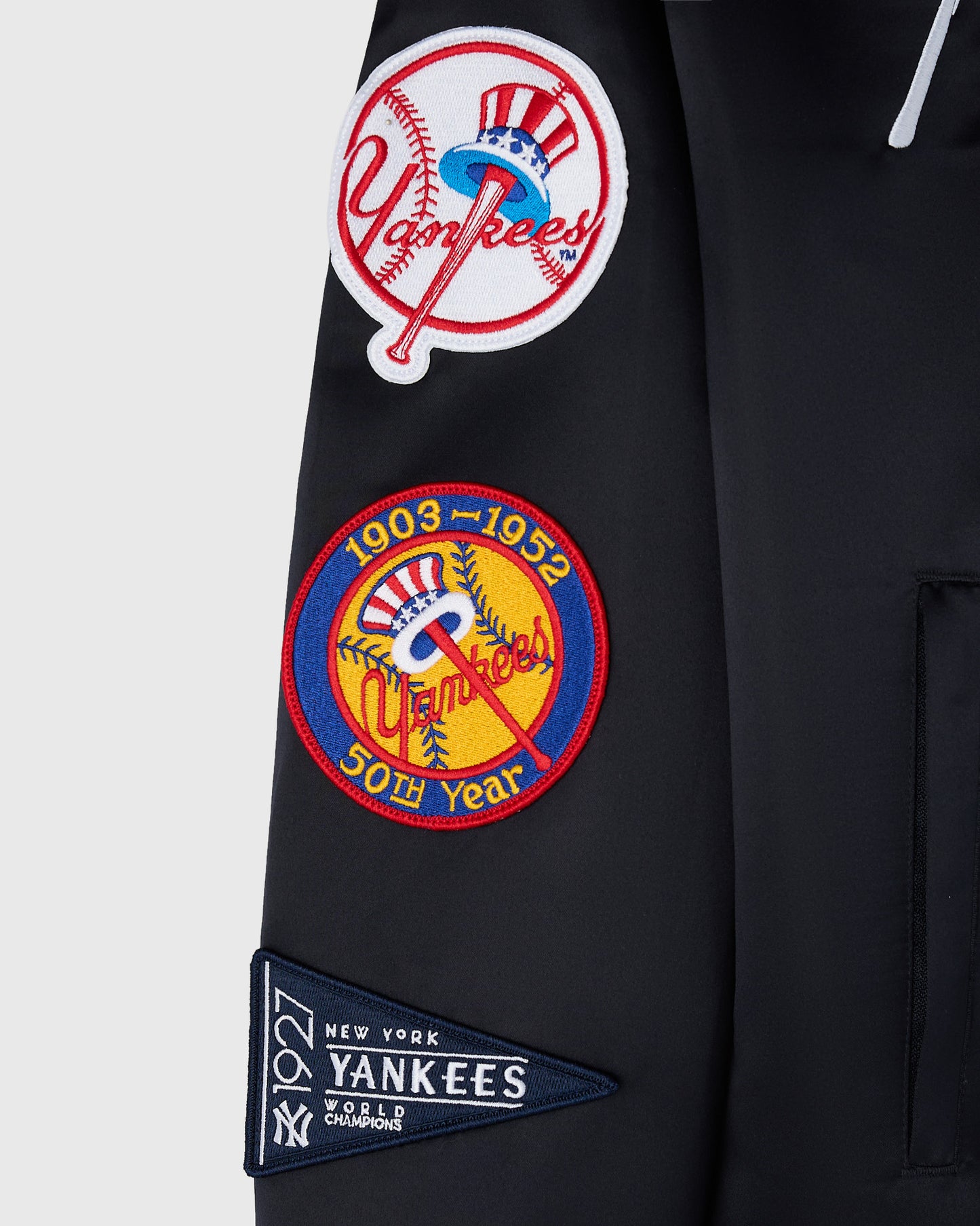 Navy varsity jacket with embroidered Yankees logos and patches including 1903-1952 50th year anniversary and 1927 World Champ
