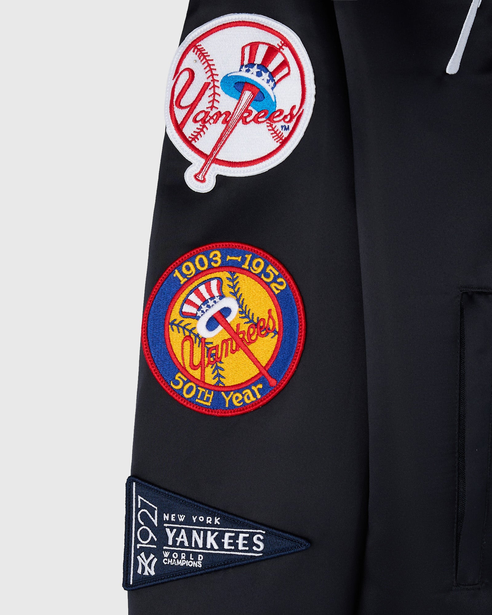 Navy varsity jacket with embroidered Yankees logos and patches including 1903-1952 50th year anniversary and 1927 World Champ