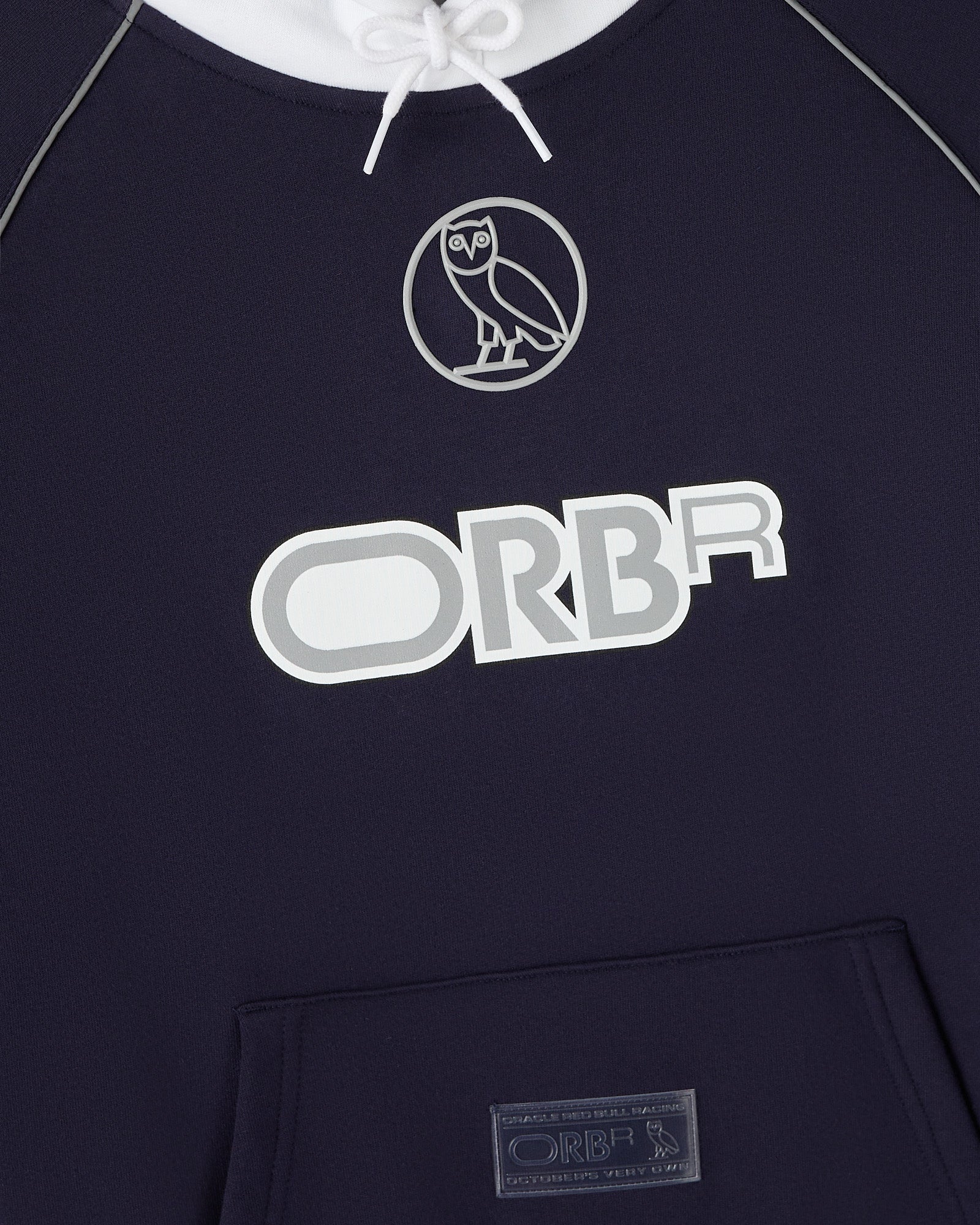 Navy hoodie with white drawstring, owl logo, and "ORBR" text on chest with kangaroo pocket.