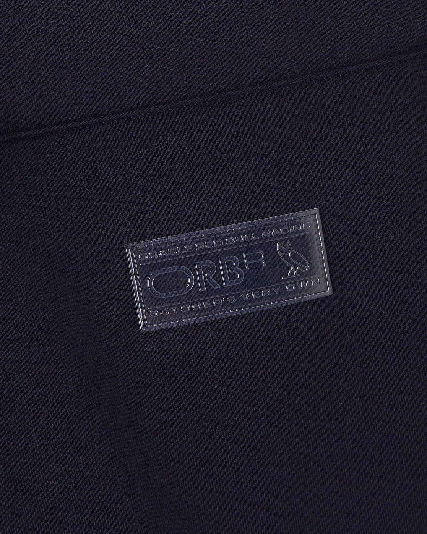 Navy blue hoodie with Oracle Red Bull Racing embossed label patch on chest.