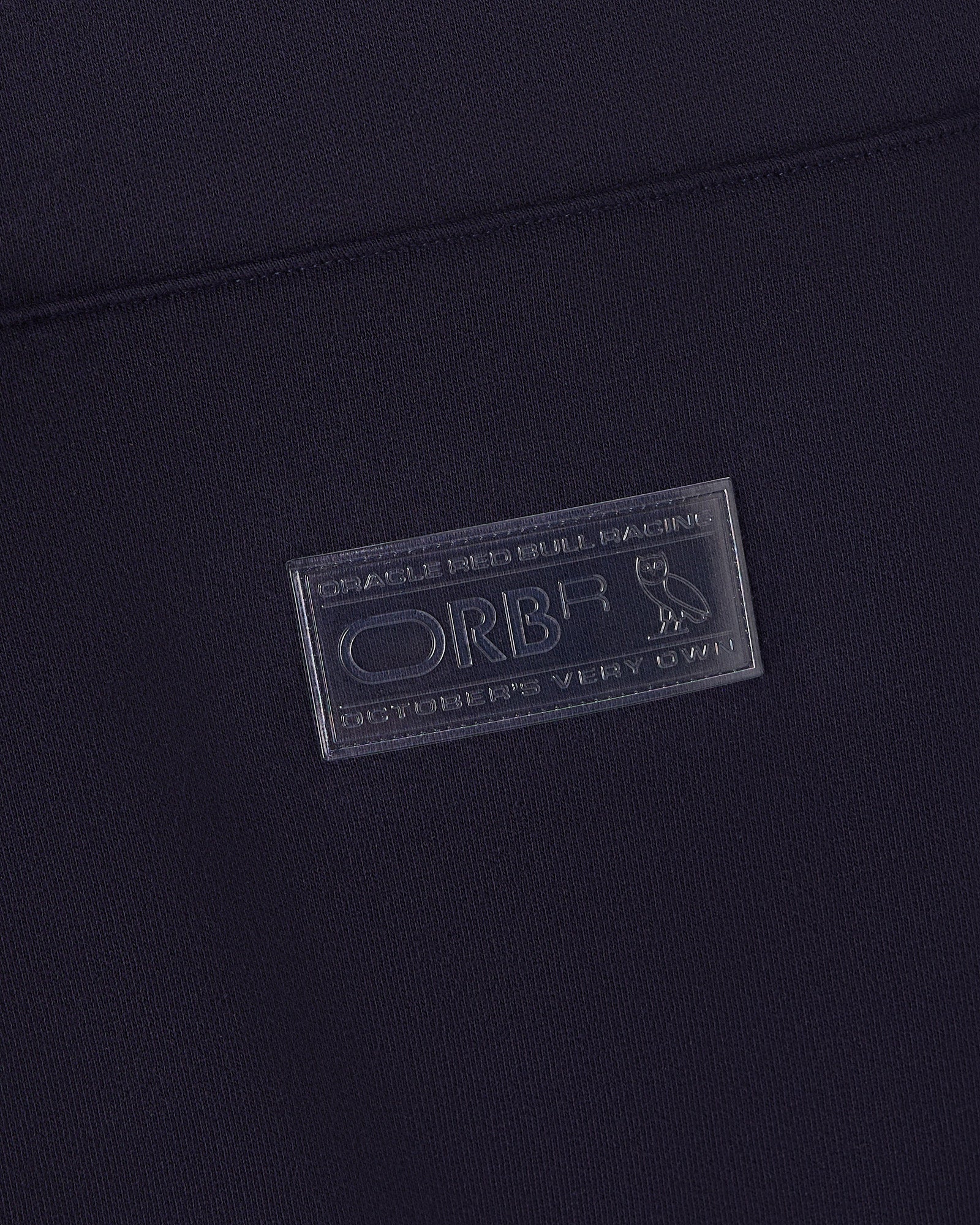 Navy blue hoodie with Oracle Red Bull Racing embossed label patch on chest.