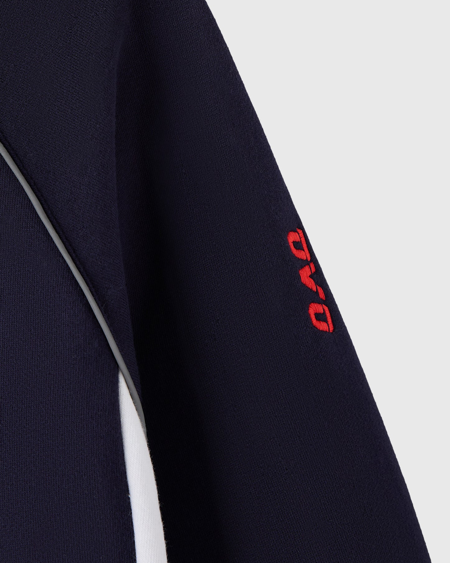 Navy hoodie with white side stripe and red logo embroidery on sleeve.